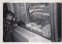 Julian Hyman playing with a farm set on a window sill at Arden Shore